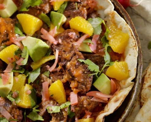Rib-Eye Steaks with Spicy Roasted Tomato Sauce on Tortillas with Radishes and Avocados