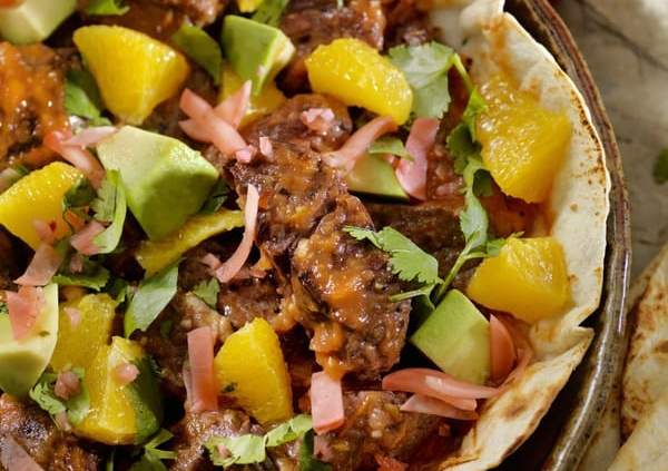 Rib-Eye Steaks with Spicy Roasted Tomato Sauce on Tortillas with Radishes and Avocados